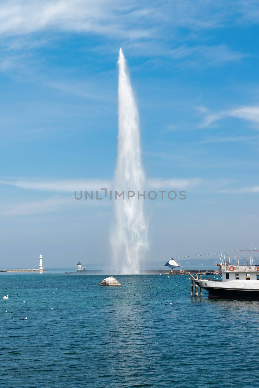 The Geneva Water Fountain, Jet d'Eau, in the city of Geneva, Switzerland. Lake Geneva. Switzerland landmark by NataliPopova