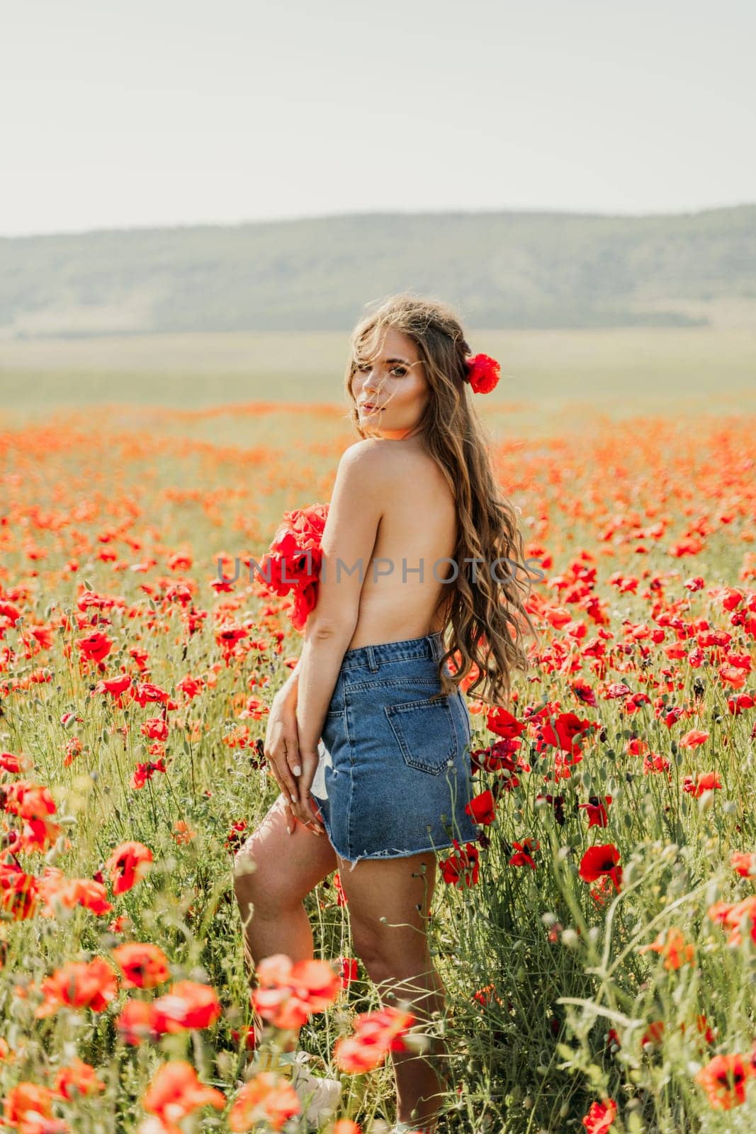 Woman poppies field. portrait happy woman with long hair in a poppy field and enjoying the beauty of nature in a warm summer day. by Matiunina