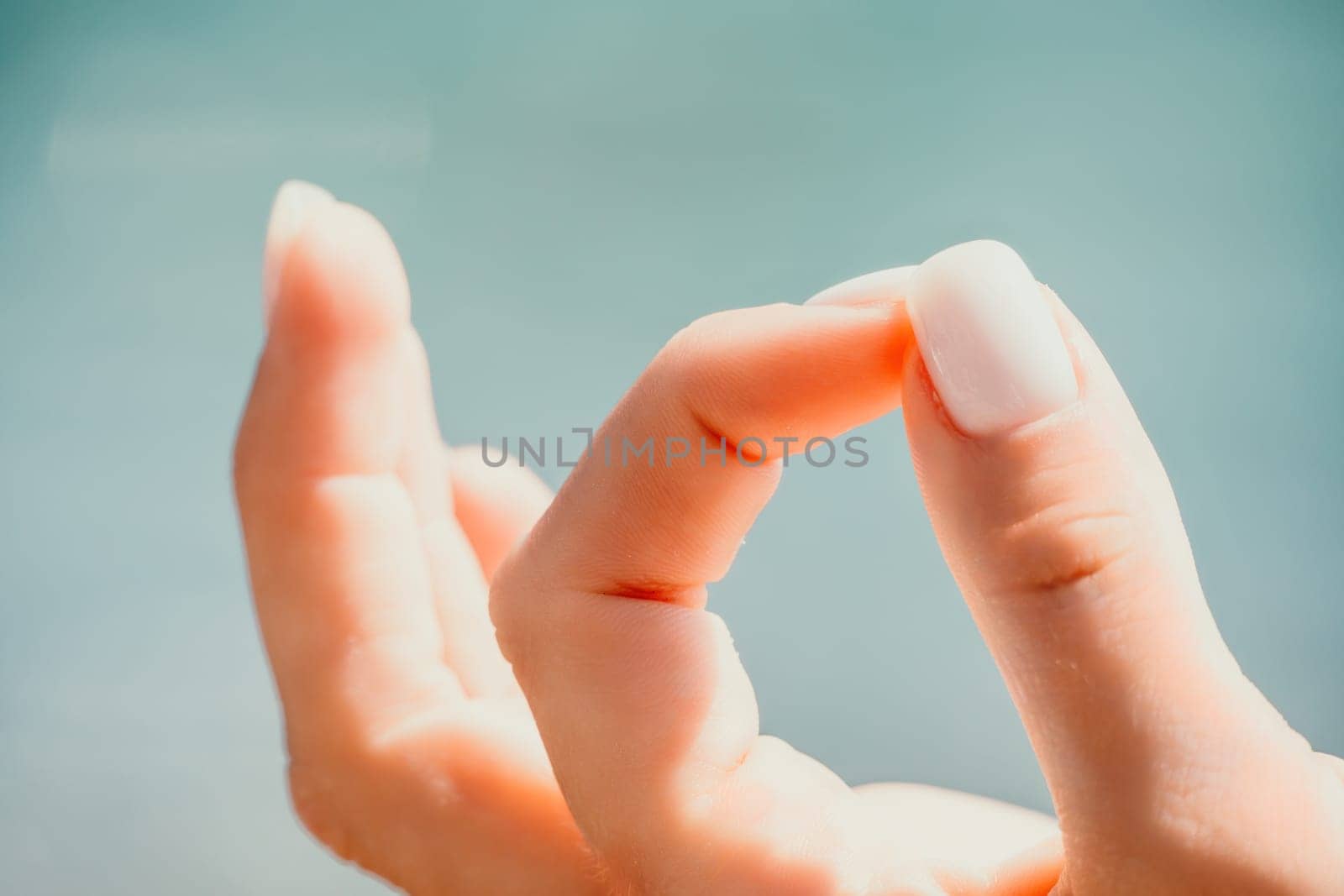 Close up Hand Gesture of Woman Doing an Outdoor Lotus Yoga Position. Close up. Blurred background