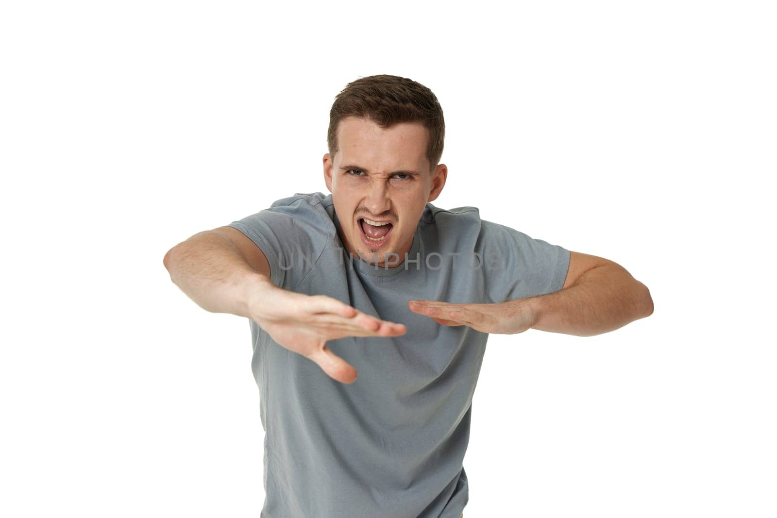 annoyed angry man fighting on white studio background