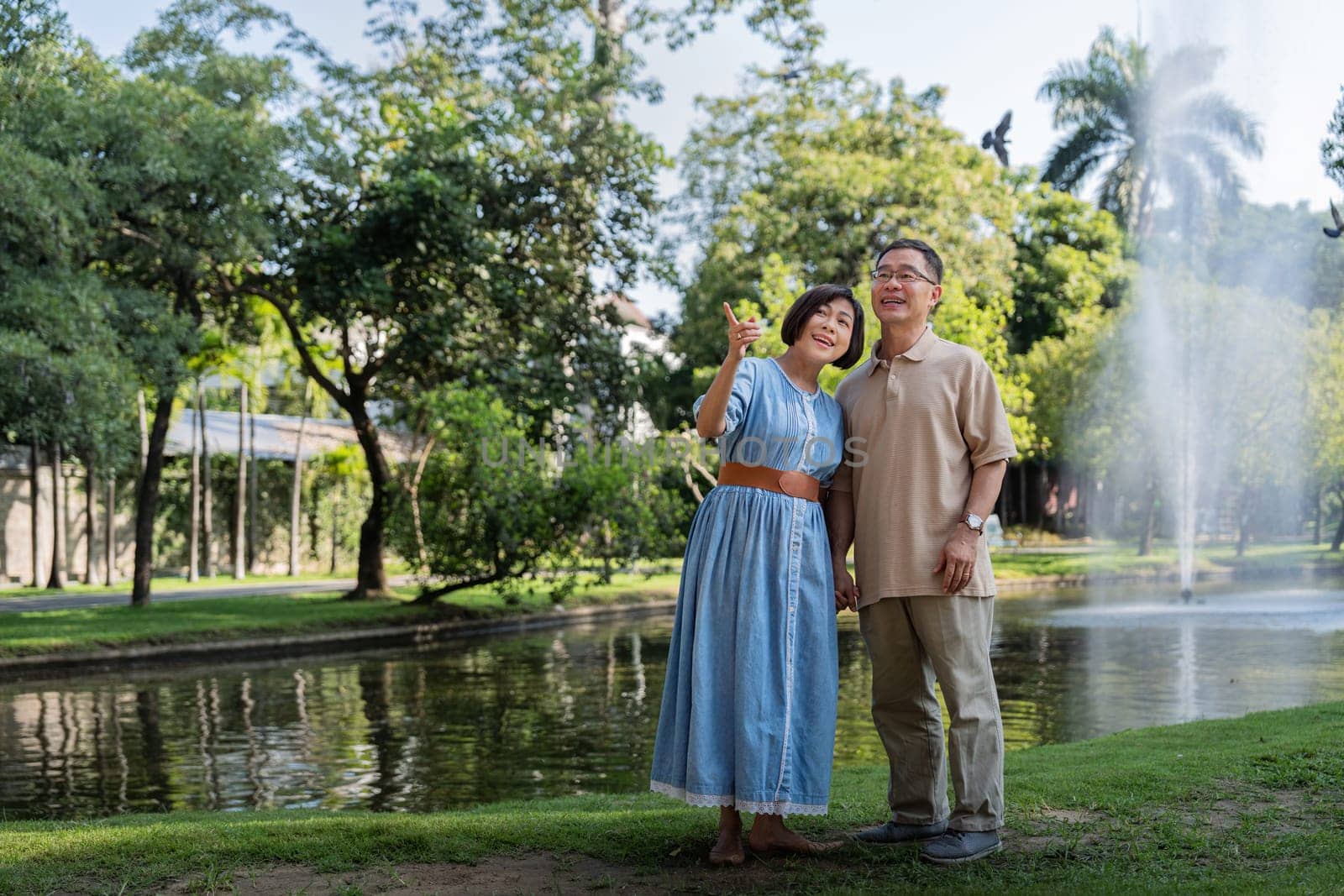 Happy active senior couple having fun outdoors in a park. Portrait of an elderly couple together by nateemee