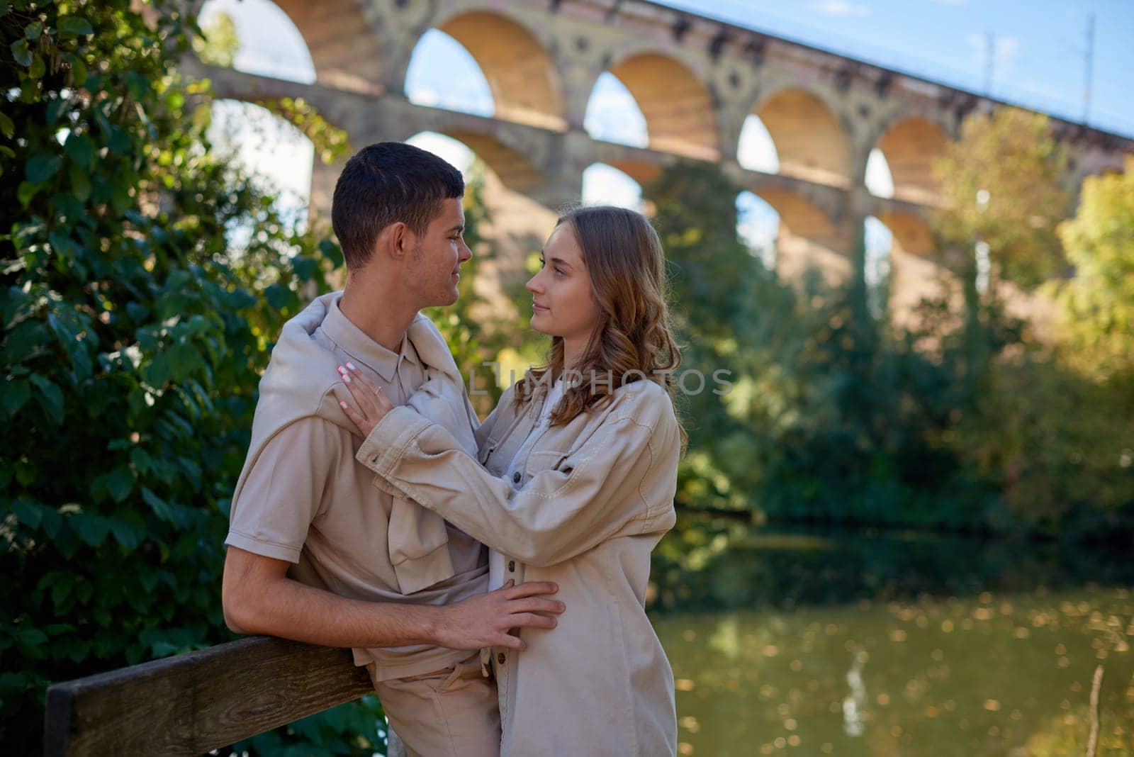 Young Cute Female Hugs Boyfriend. In Autumn Outdoor. Lovers Walking in Park. Attractive Funny Couple. Lovestory in Forest. Man and Woman. Cute Lovers in the Park. Family Concept. Happy Couple.