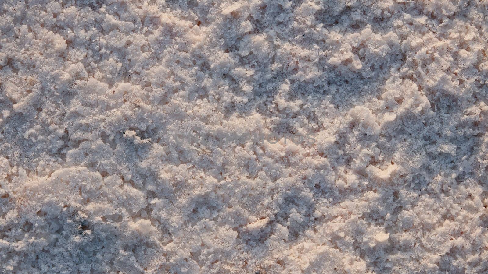 Natural salt Close up. Surface of a salt lake. Natural background. Natural formations of Salt crystals. Top view on Pink salt lake.