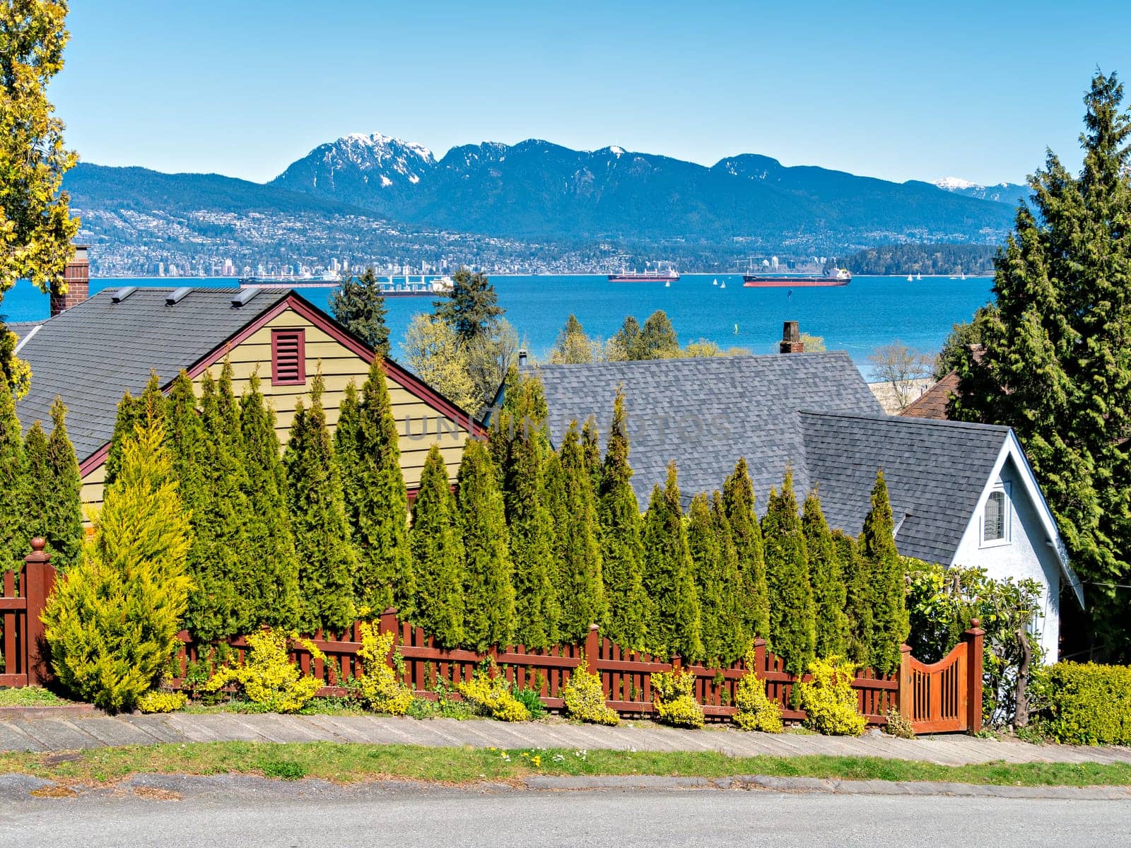 Ocean-going cargo vessels in Coal harbor bay in Vancouver. View from residential area