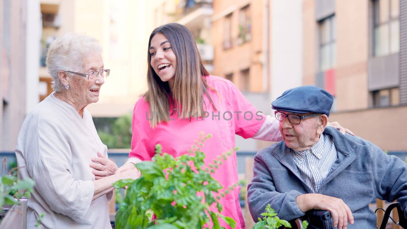 Photo of a caregiver singing with senior people in the terrace of a geriatrics