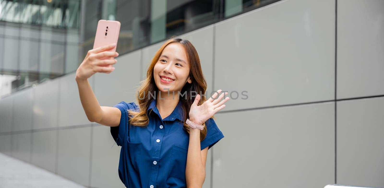 Trendy young woman capturing a selfie with her smartphone in the city by Sorapop