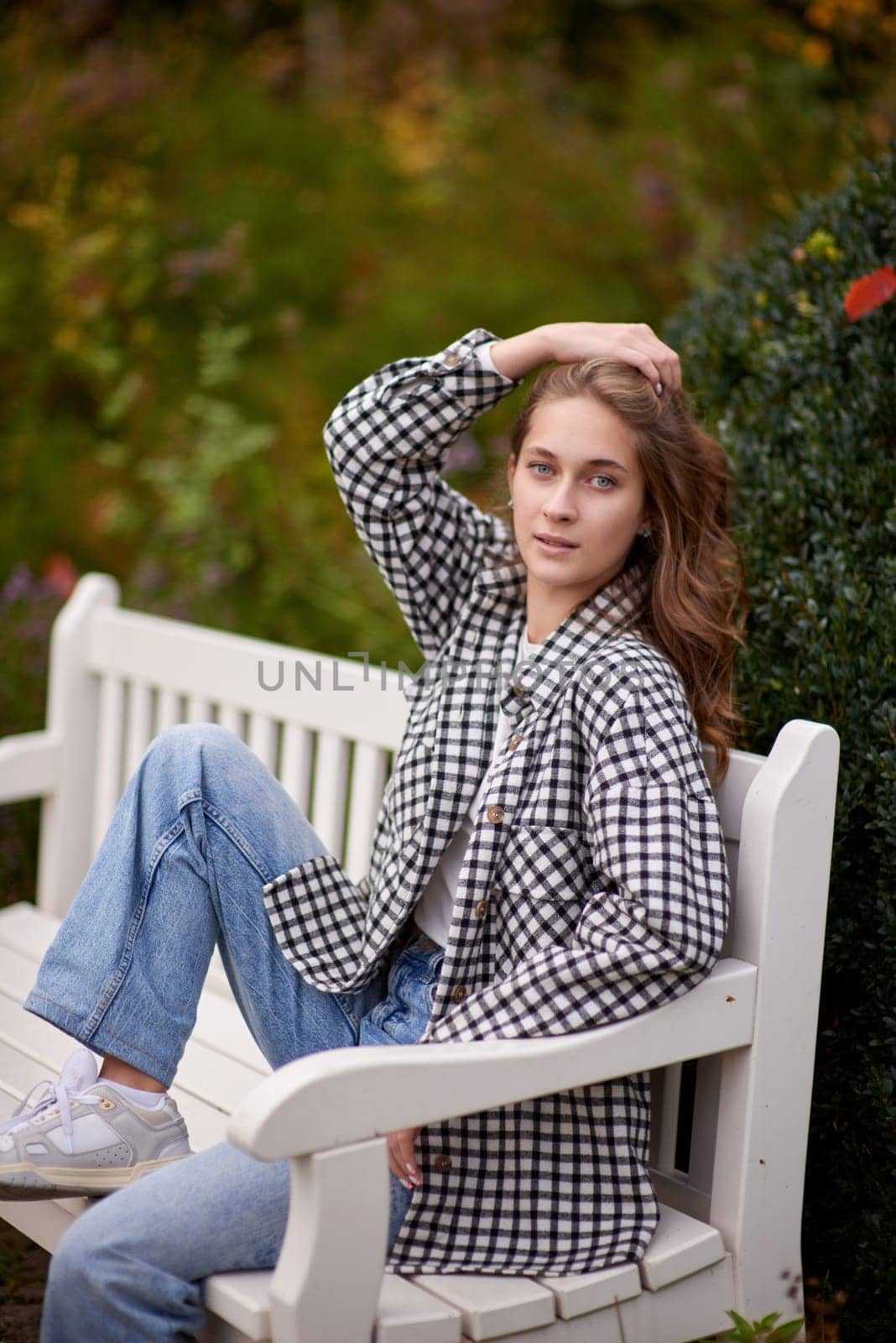 Charming Autumn Casual: Beautiful Girl on Park Bench. Autumn Grace: Stylish Casual Amidst Fall Foliage. Casual Chic in Autumn: Beauty on a Park Bench by Andrii_Ko