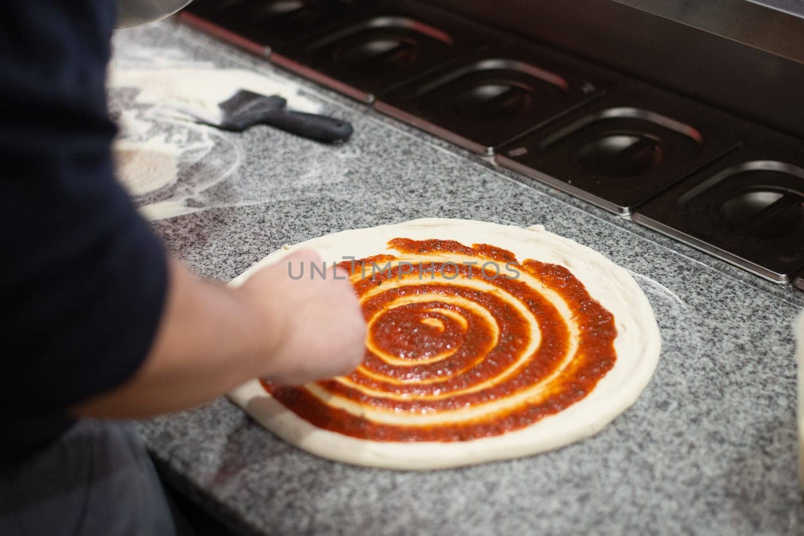 Hands prepairing real italian home made pizza in Lithuania. High quality photo