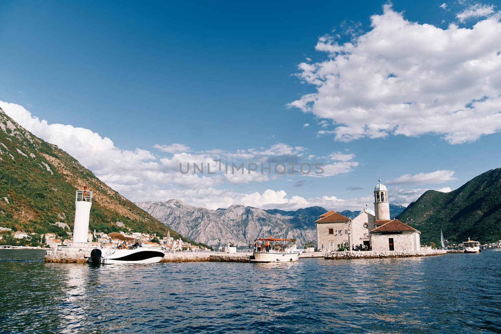 Excursion boats are moored near the island of Gospa od Skrpjela. Montenegro. High quality photo
