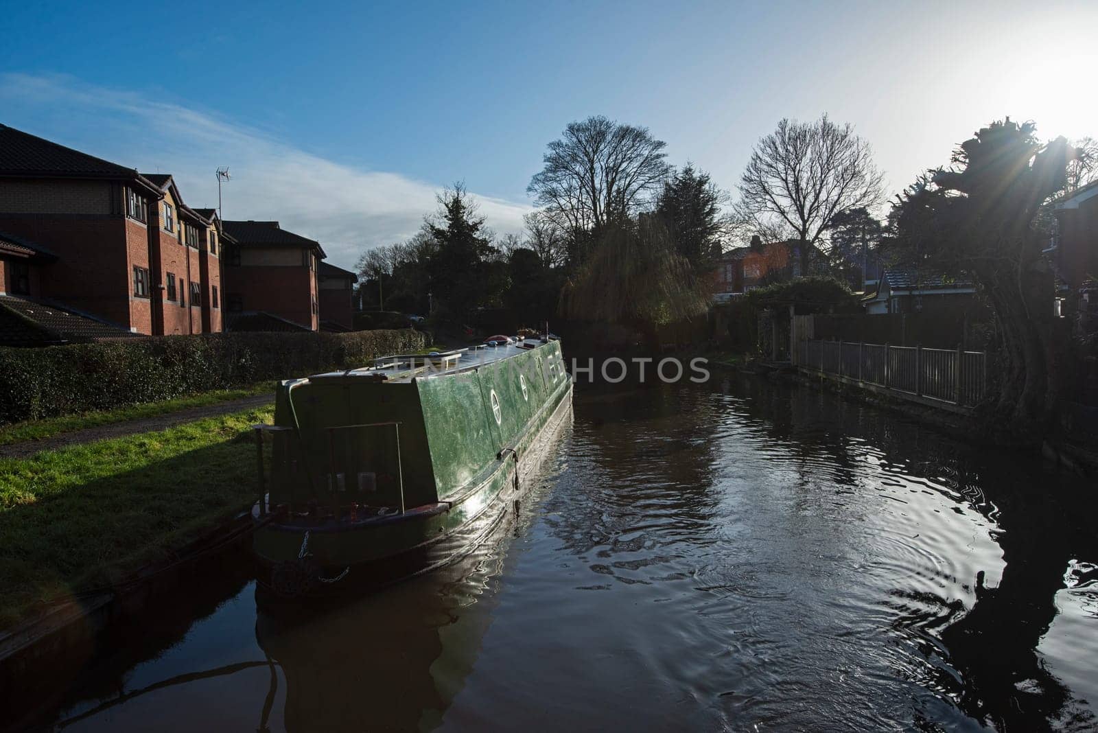 Narrowboat on a British canal in urban setting by paulvinten