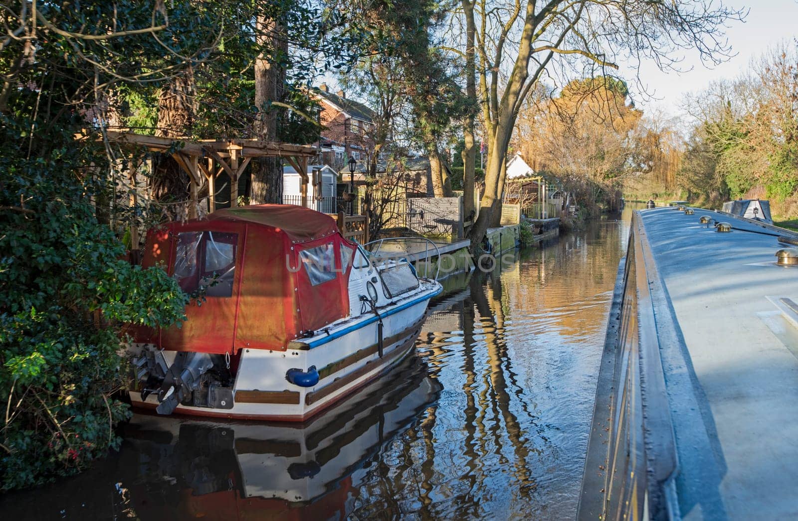 Narrowboat on a British canal in rural setting by paulvinten