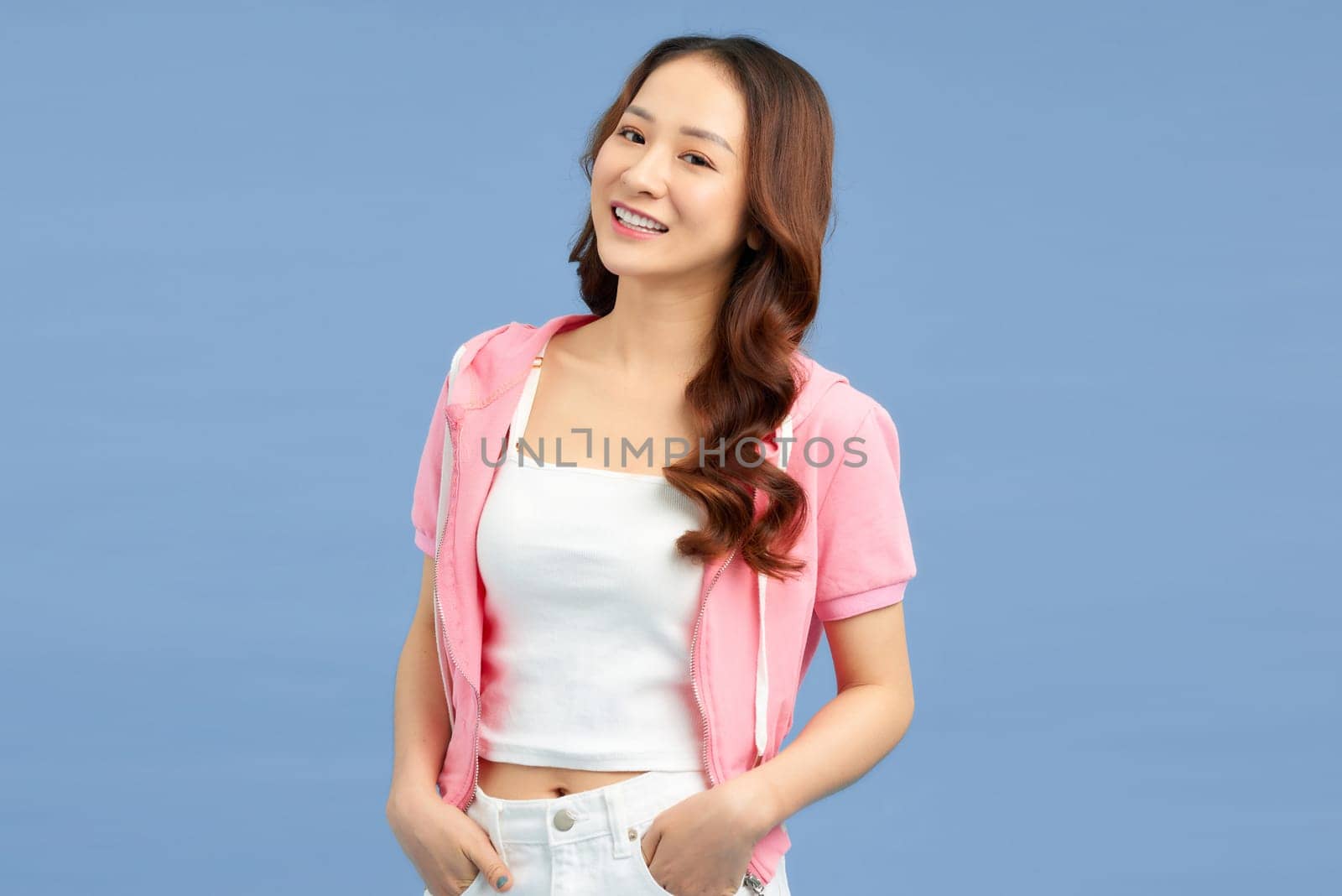 Beautiful woman in the template of a women's sweatshirt of pink color. Hands in pockets