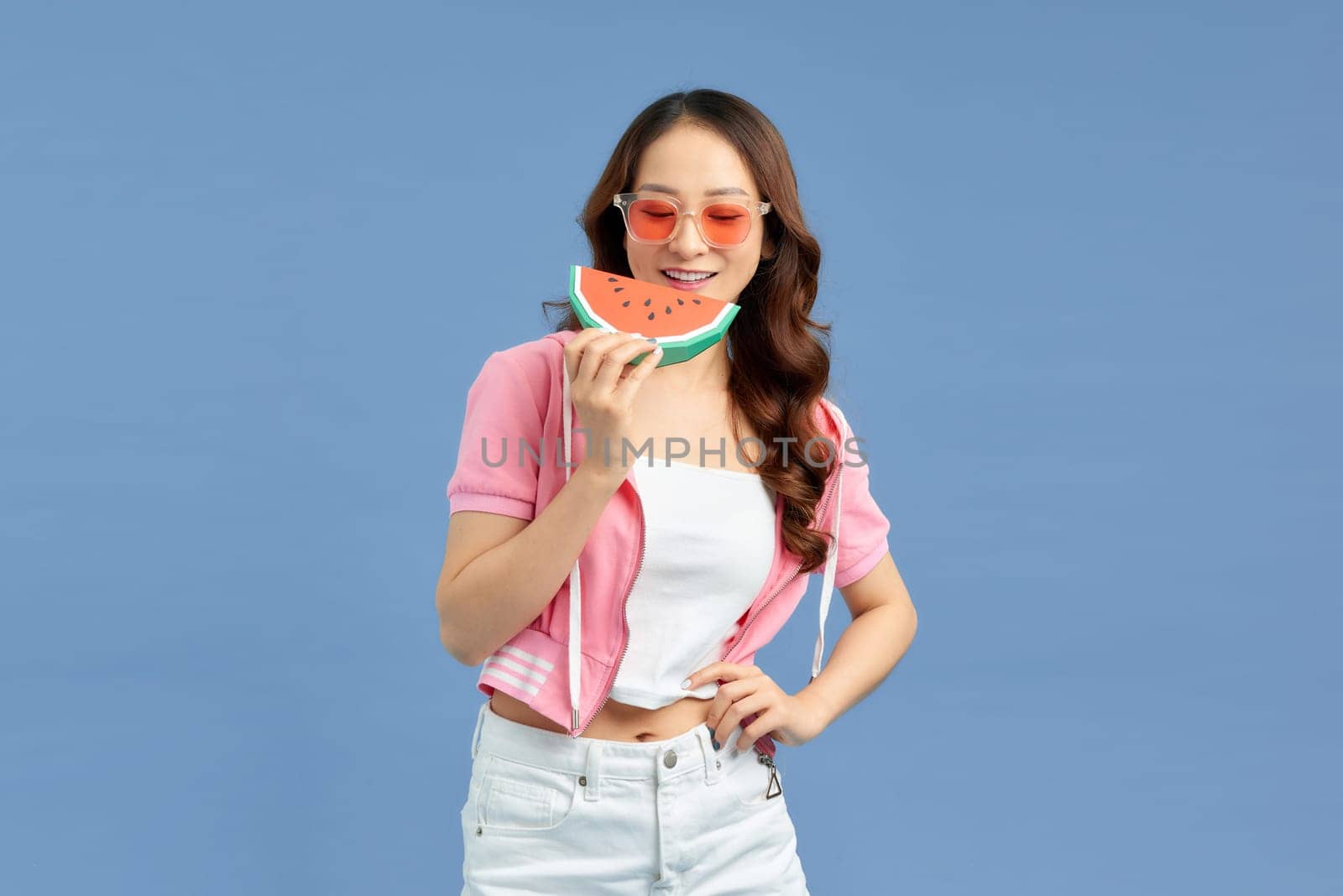 Young Asian woman eating watermelon on background by makidotvn