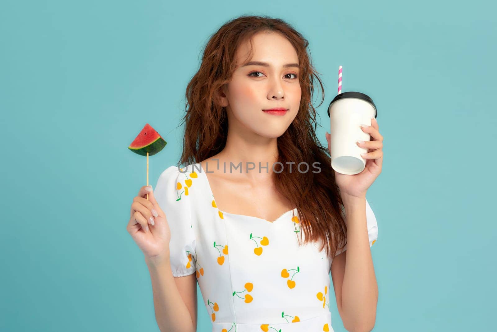 Young woman drinking watermelon juice on blue banner