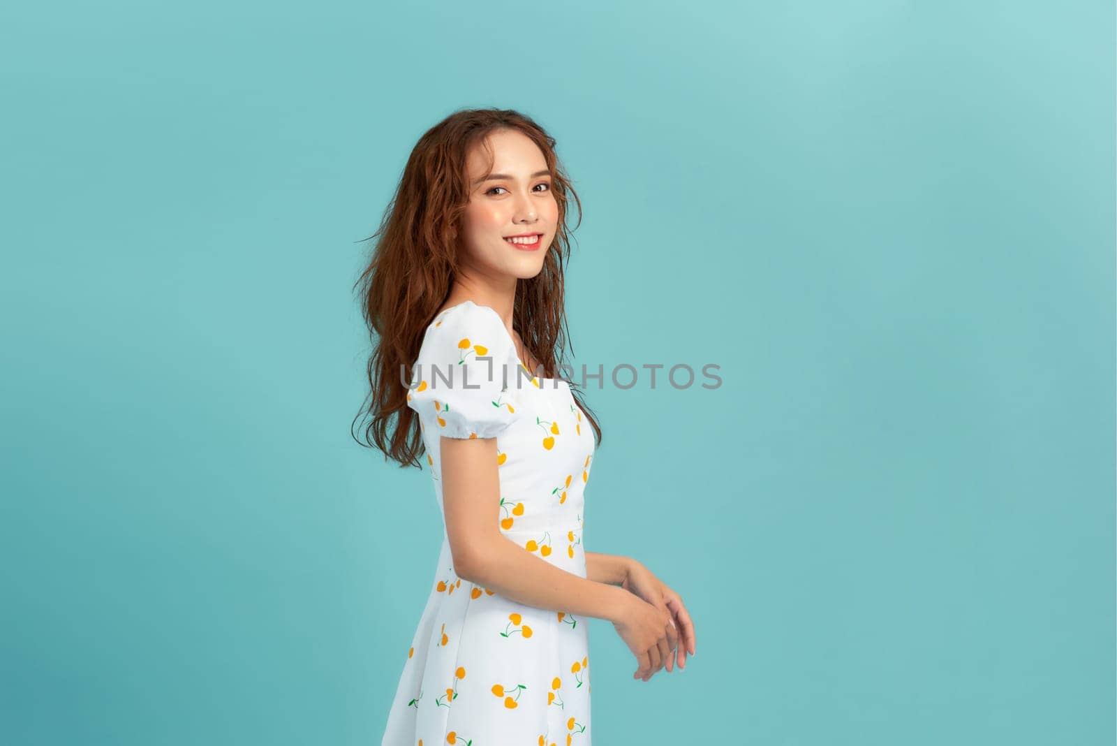 Portrait of young beautiful smiling female in trendy summer dress.
