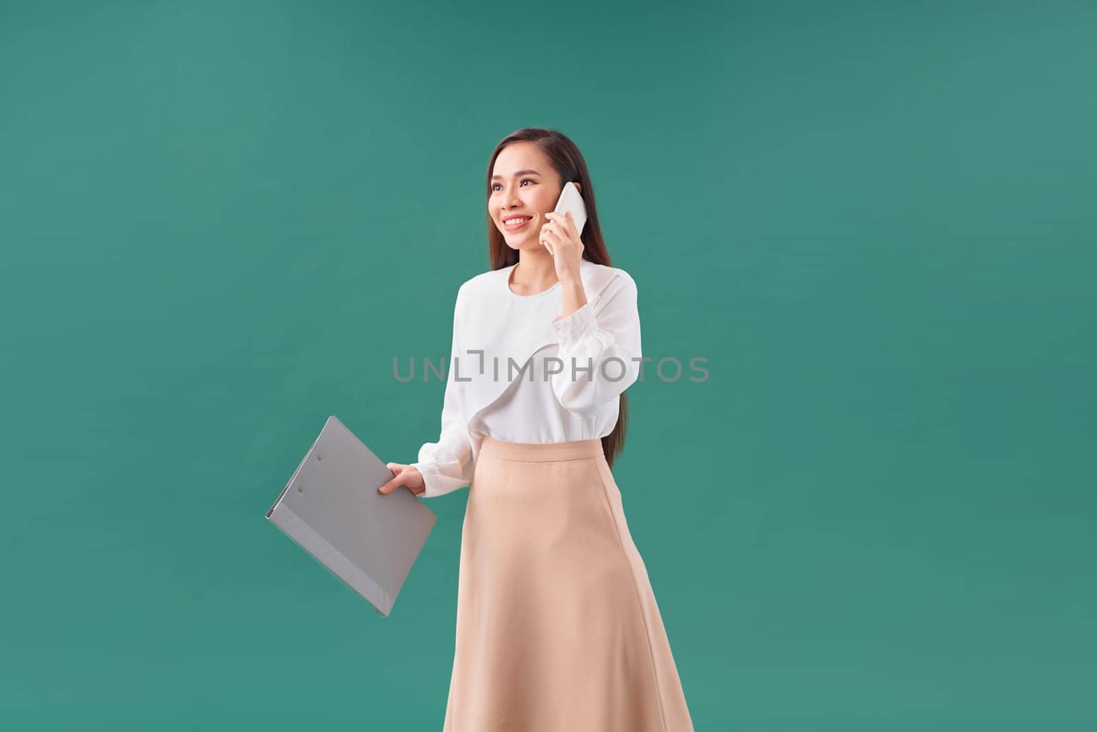 Beautiful girl uses mobile phone for work, calls clients, sends text messages by makidotvn