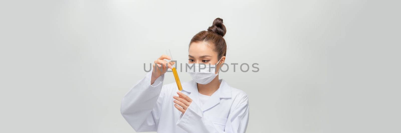 Female scientist in lab coat with chemical glassware. Isolated on white.