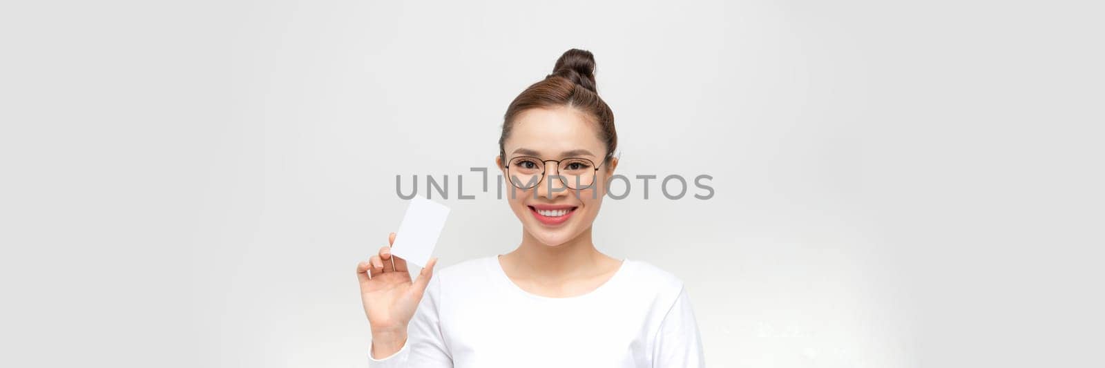 Woman showing business card on white background