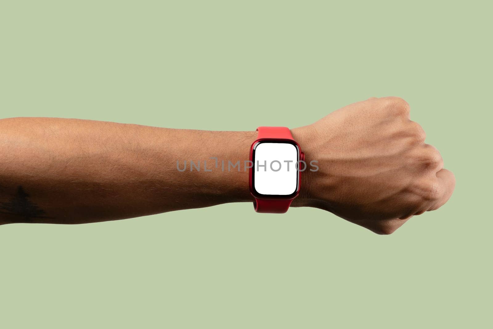 black male arm wearing red smartwatch with blank screen isolated on light green by TropicalNinjaStudio