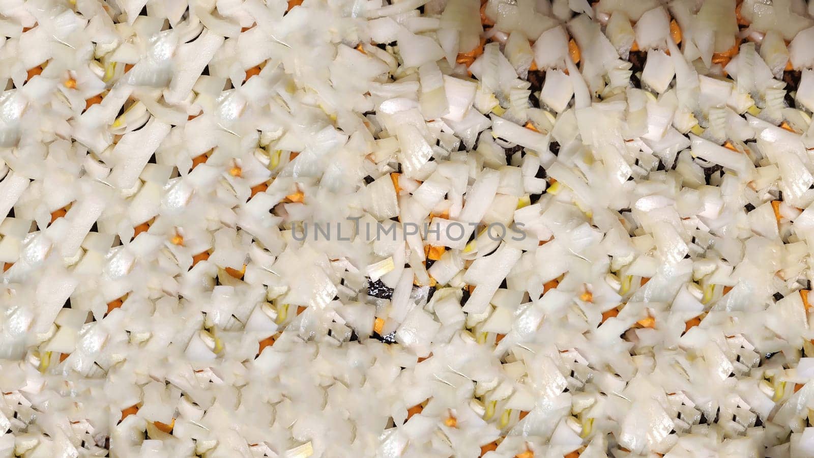 Pieces of onion and carrot, prepared for frying. Background, texture, pattern, place for text, copy space