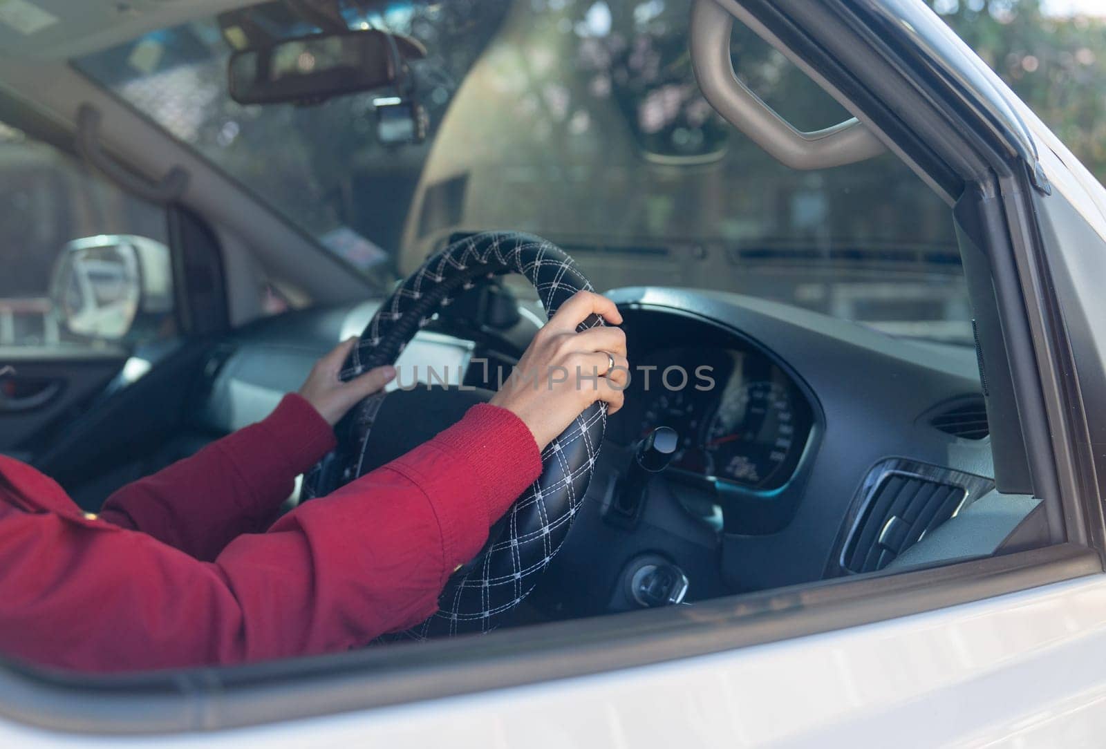 Close up hands of woman hold joystick or steering wheel of car with concept of safe drive and insurance of vehicle.
