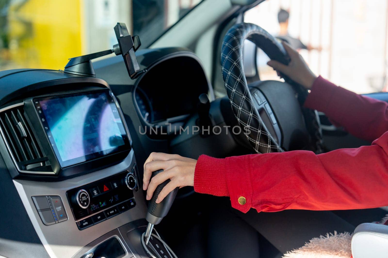 Close up hands of woman hold joystick or steering wheel and gear lever of car with concept of safe drive and insurance of vehicle. by nrradmin