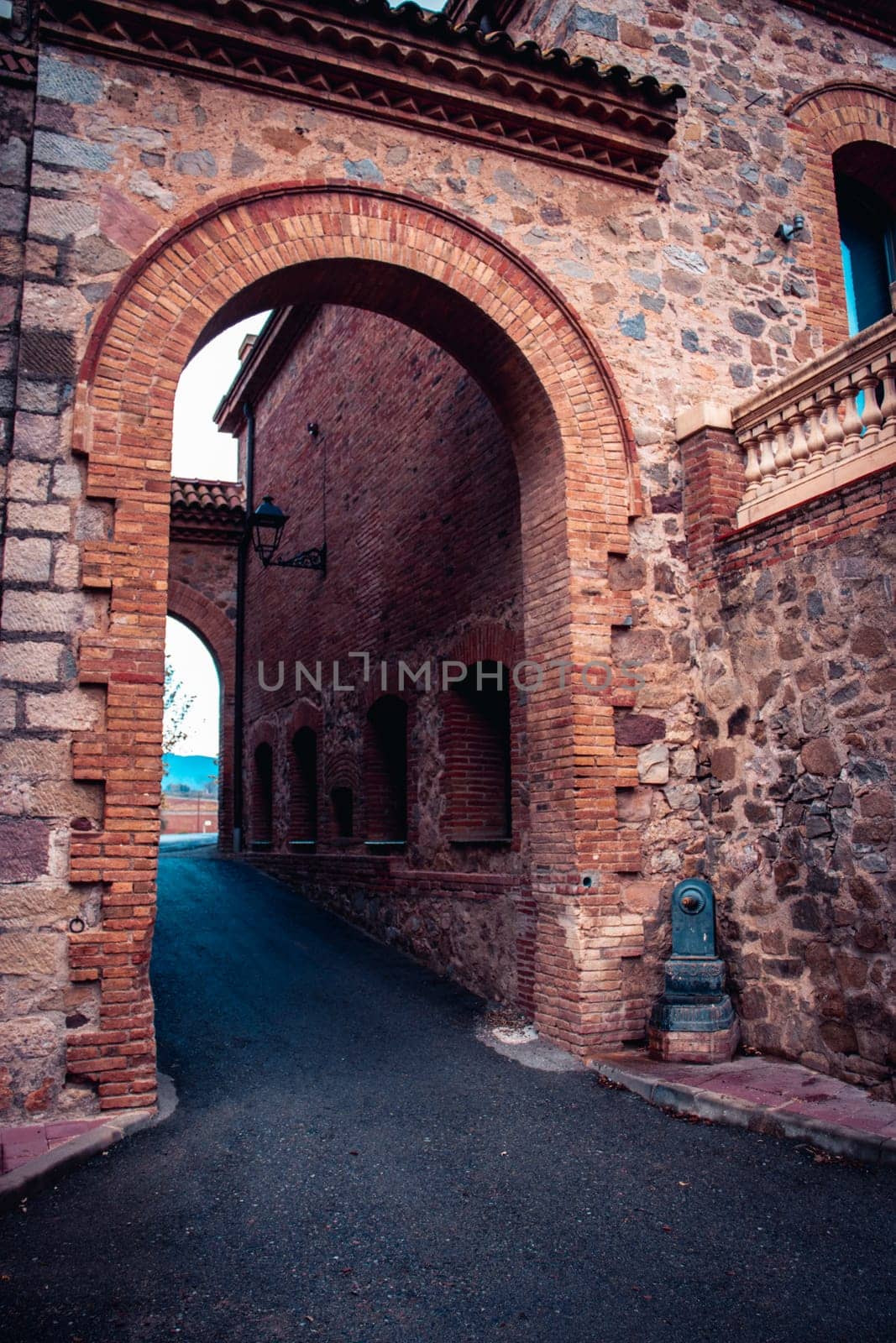 The exterior of an old farm concept photo. An arch through which you can see the backyard an old stone building. by _Nataly_Nati_