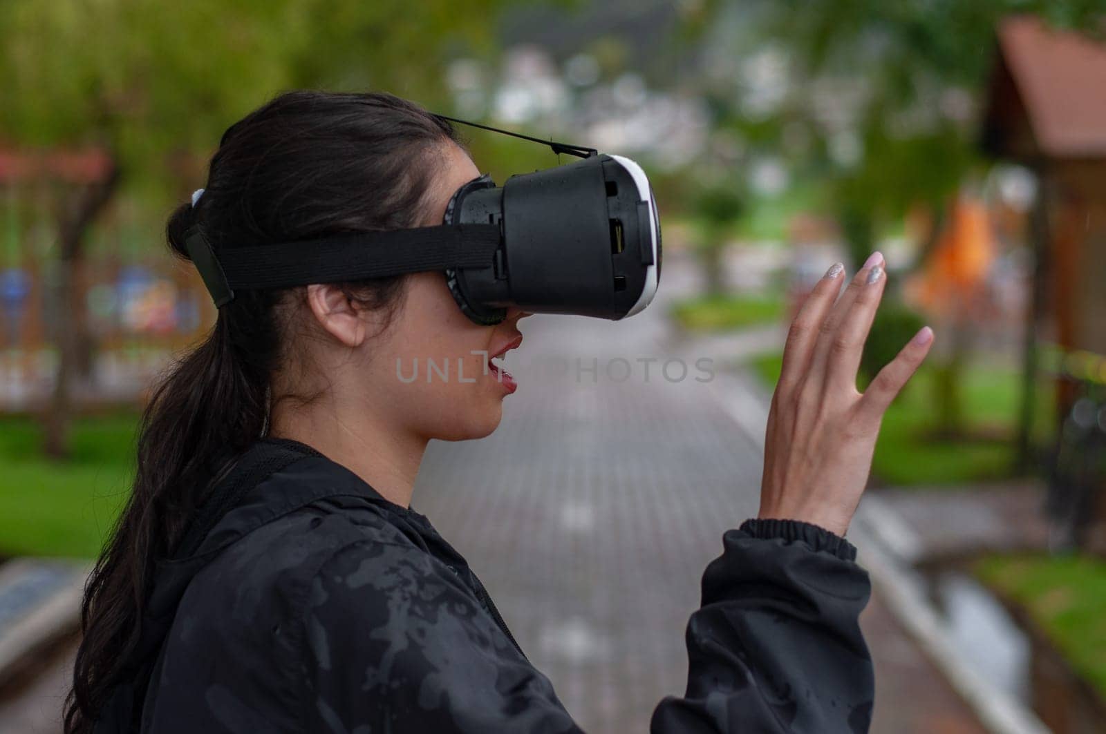 girl with augmented reality glasses experiencing the intelligence of the future with her hands and mouth open in surprise. High quality photo