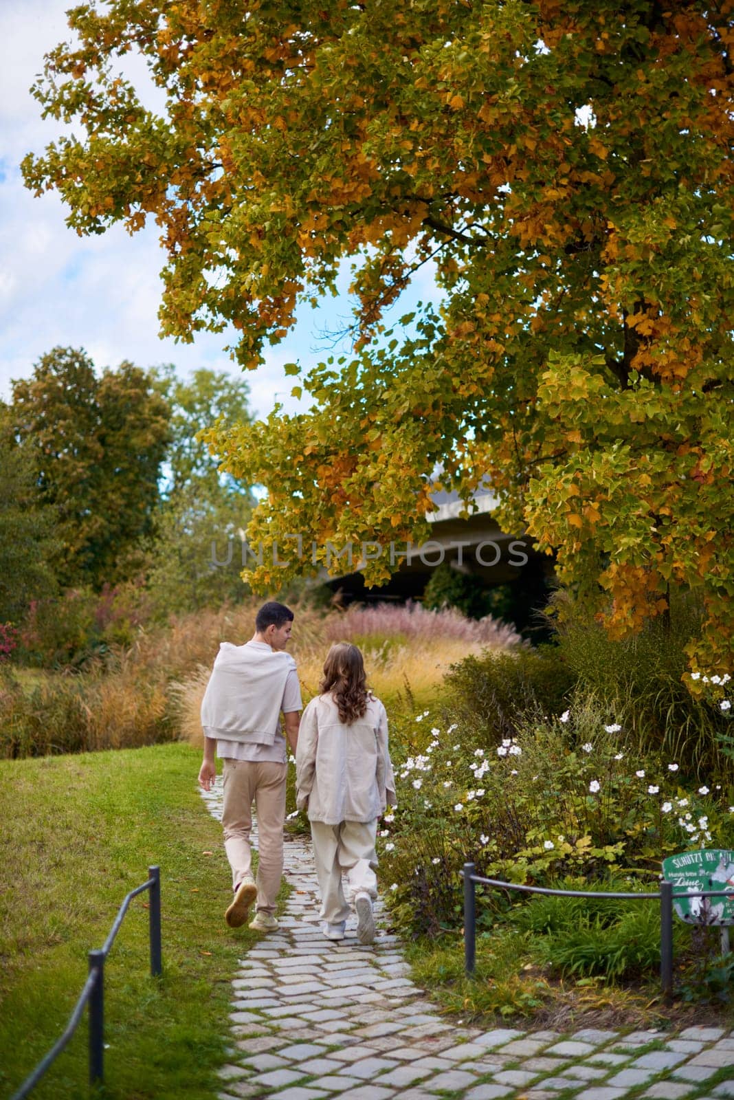 Young Cute Female Hugs Boyfriend. In Autumn Outdoor. Lovers Walking in Park. Attractive Funny Couple. Lovestory in Forest. Man and Woman. Cute Lovers in the Park. Family Concept. Happy Couple.