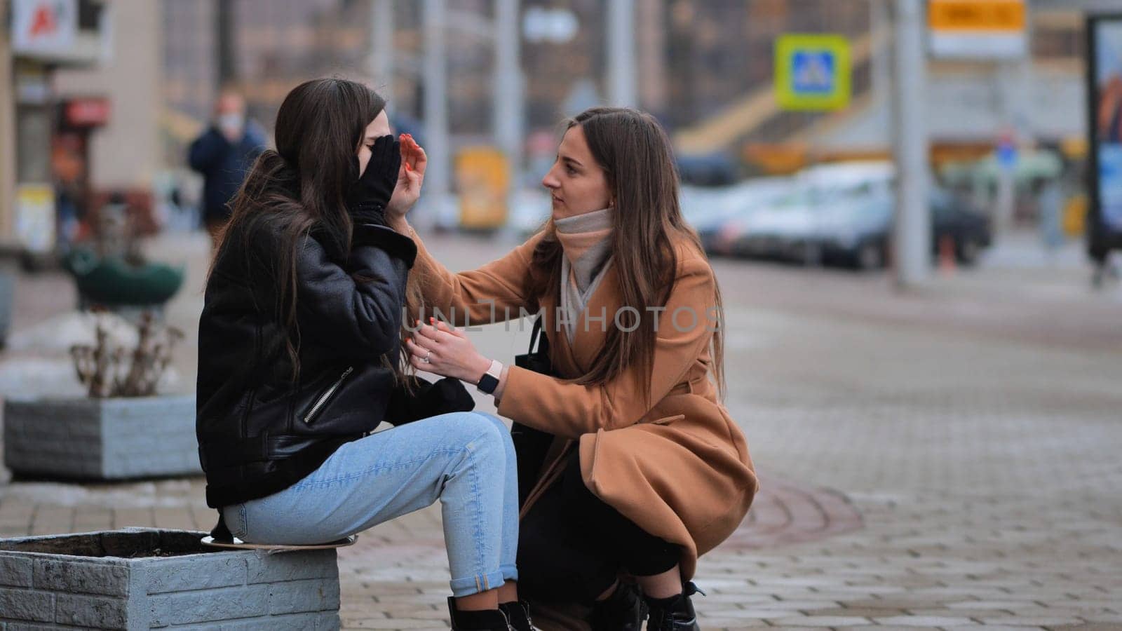 A girl calms a desperate girl on the street. by DovidPro