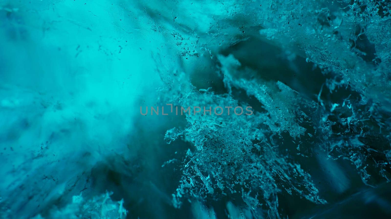 Majestic ice rocks in vatnajokull caves, transparent blue blocks of ice melting after global warming in iceland. Climate change affecting icelandic glaciers and polar nature. Handheld shot.