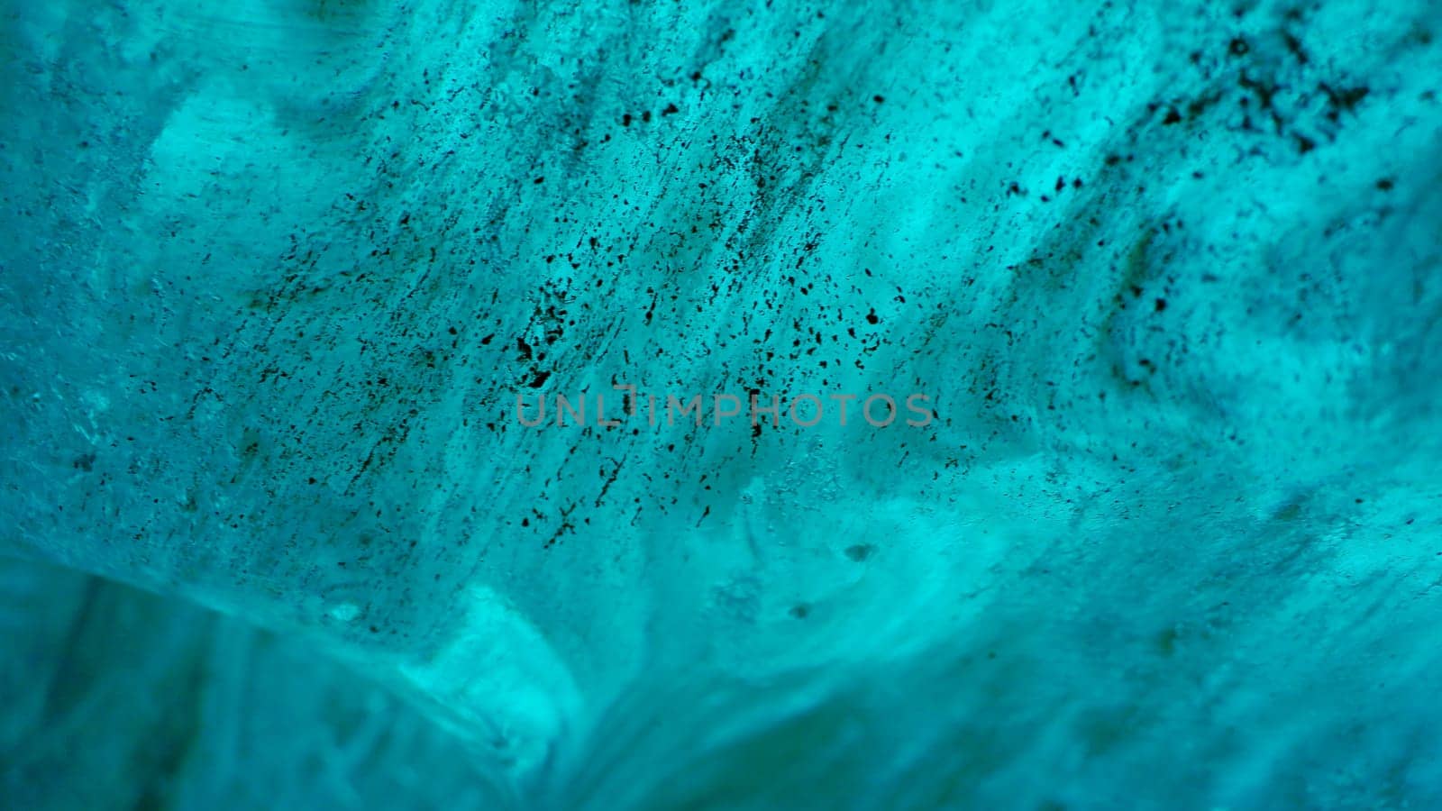 Massive ice blocks inside crevasse, transparent vatnajokull ice caves in iceland. Beautiful blue glacier on wintry frozen path, icy rocks covered in frost with cracked texture. Handheld shot.