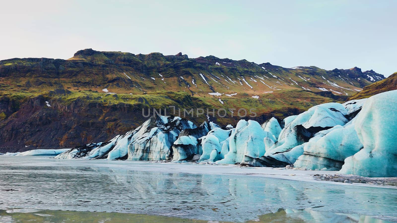 Majestic vatnajokull glacier in iceland with massive ice cap and frost floating on arctic lake, icelandic scenic route. Beautiful nordic nature with polar icebergs snowy mountains.