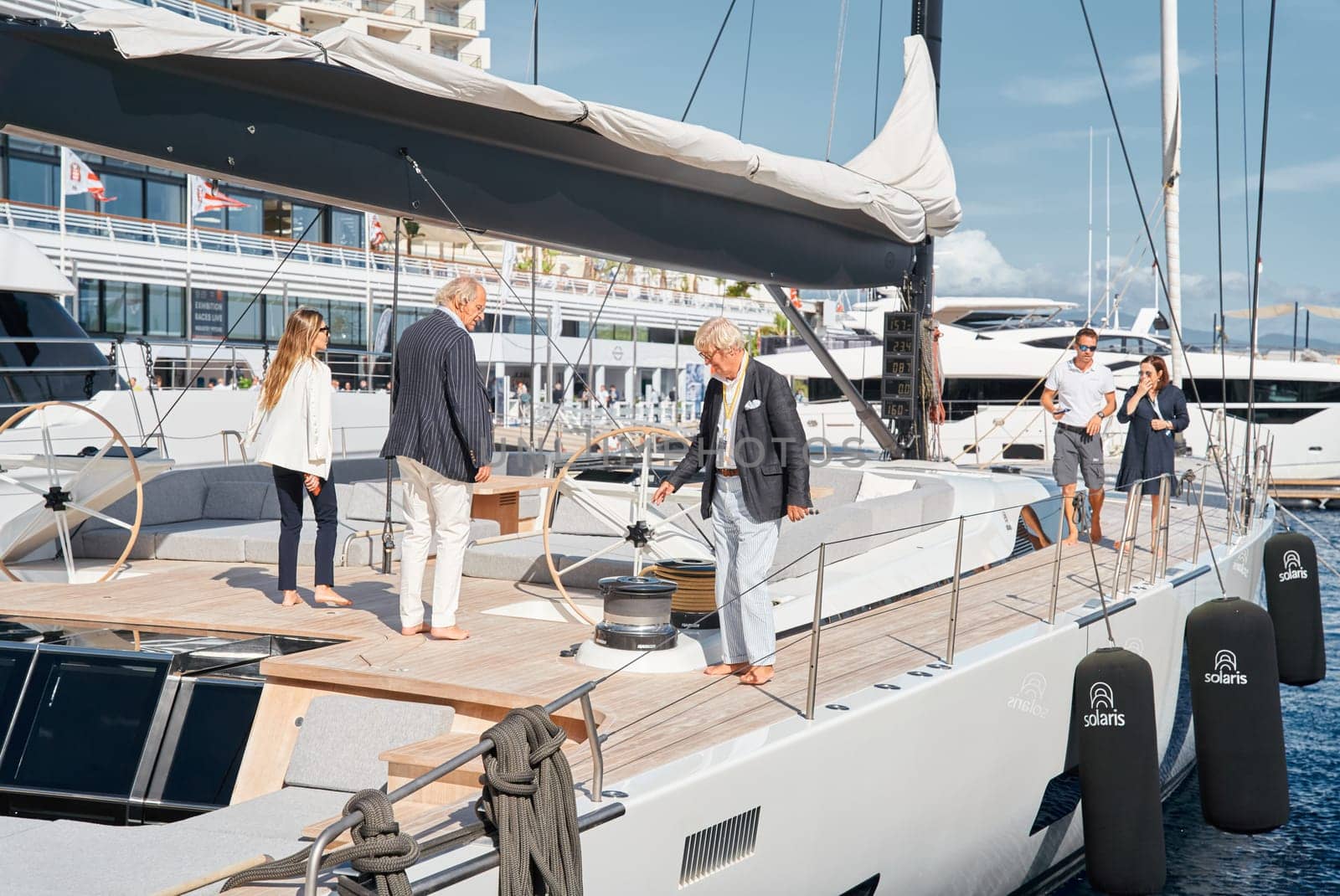 Monaco, Monte Carlo, 29 September 2022 - Invited wealthy clients inspect mega yachts at the largest fair exhibition in the world yacht show MYS, port Hercules, yacht brokers, sunny weather. High quality photo