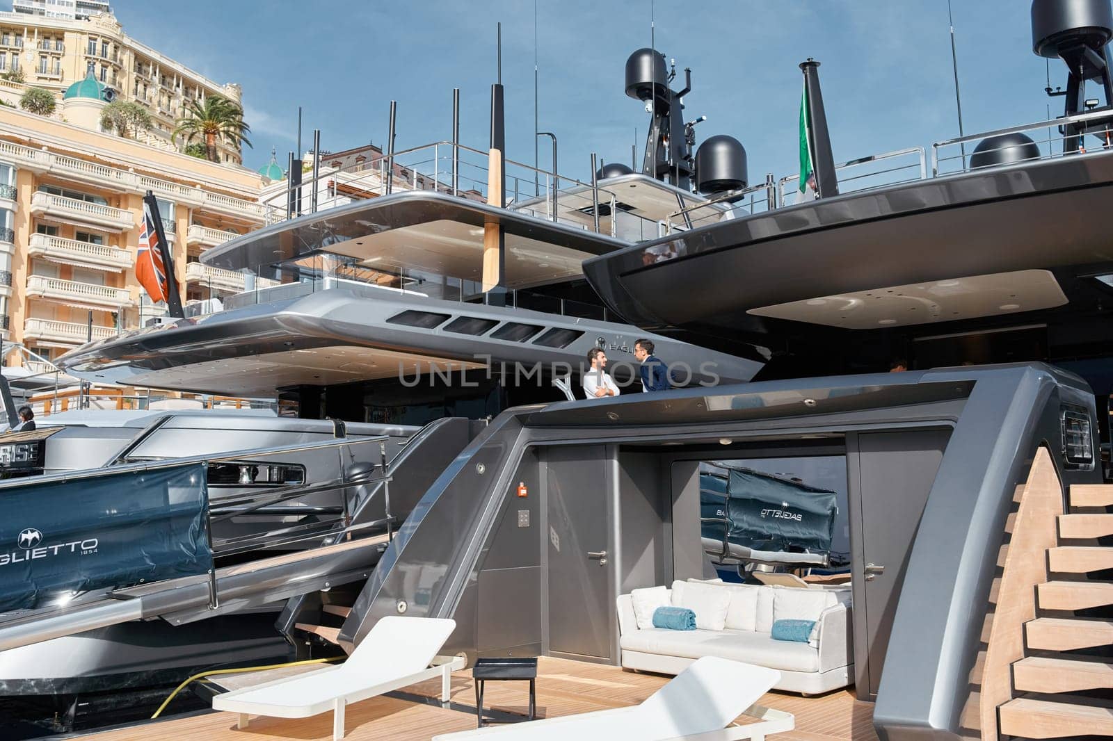 Monaco, Monte Carlo, 29 September 2022 - Invited wealthy clients inspect mega yachts at the largest fair exhibition in the world yacht show MYS, port Hercules, yacht brokers, sunny weather by vladimirdrozdin