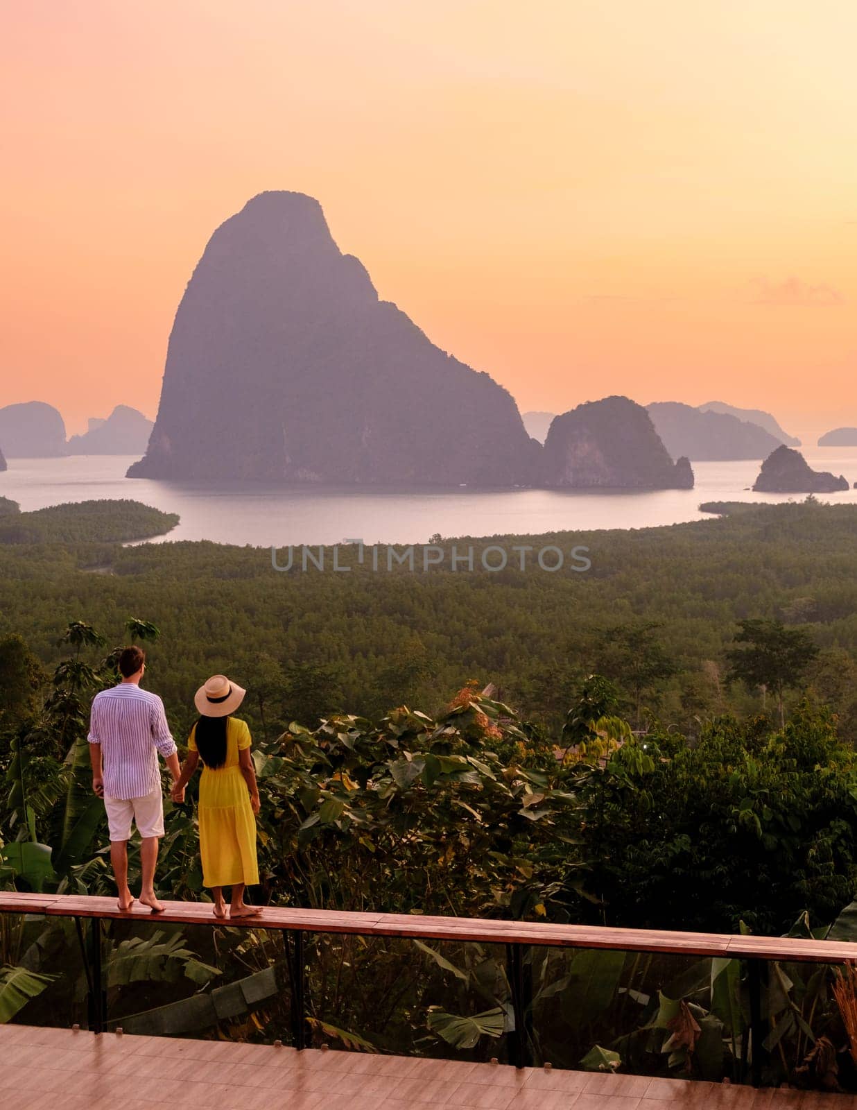 Couple watching sunrise at Sametnangshe viewpoint of mountains in Phangnga bay Thailand by fokkebok