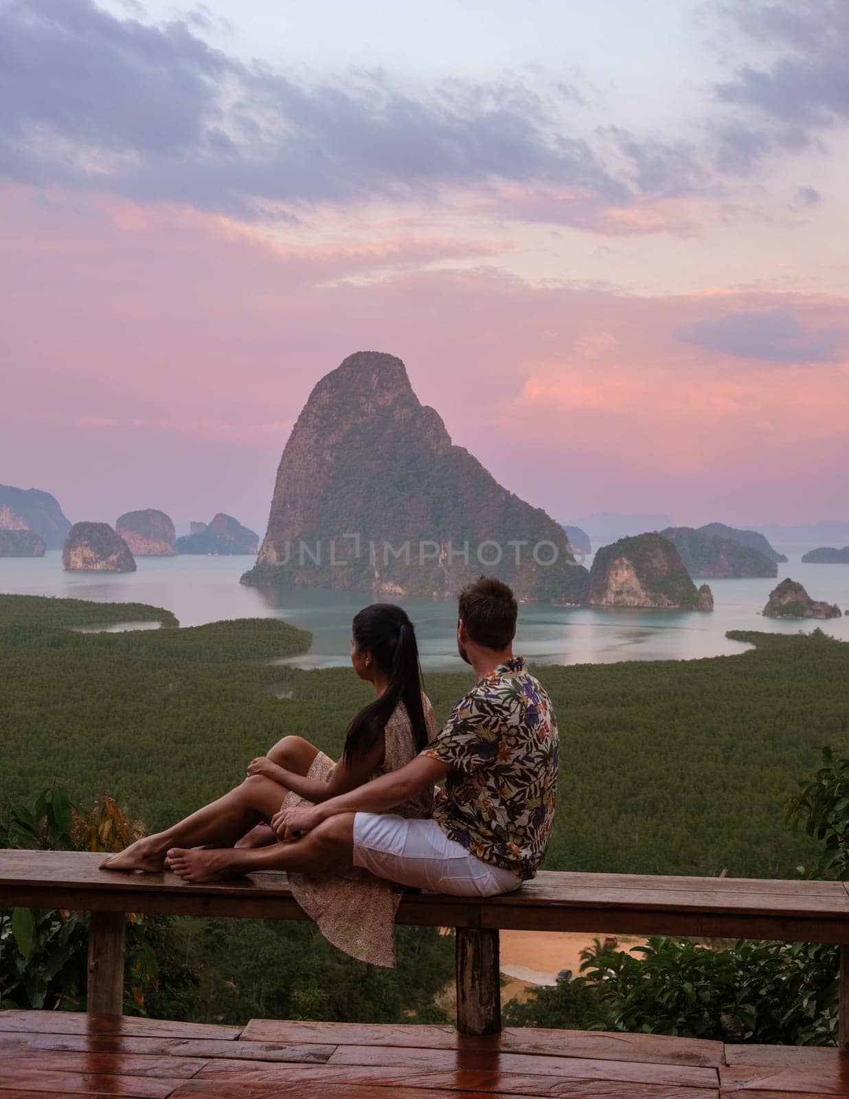 A couple of men and woman watching the sunrise at Sametnangshe viewpoint in Phangnga Bay with mangrove forest in the Andaman Sea, Sametnangshe mountain Phangnga, Thailand