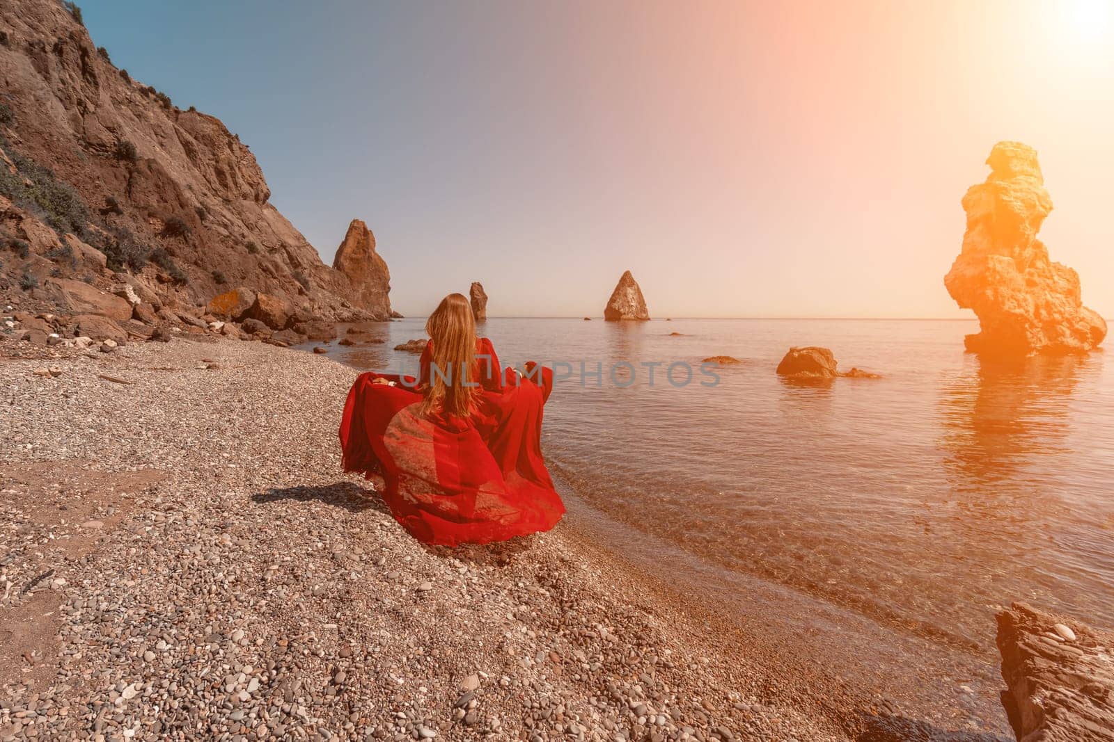 woman sea red dress Happy woman in a flying red dress and with long hair, runs on the seashore by Matiunina