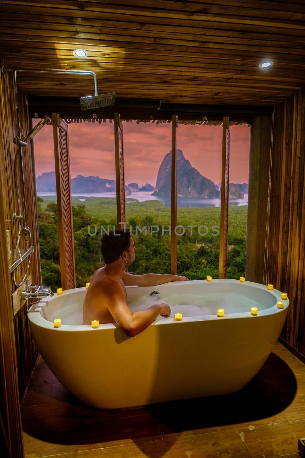 A man in a bathtub at Sametnangshe viewpoint of mountains in Phangnga bay Thailand by fokkebok