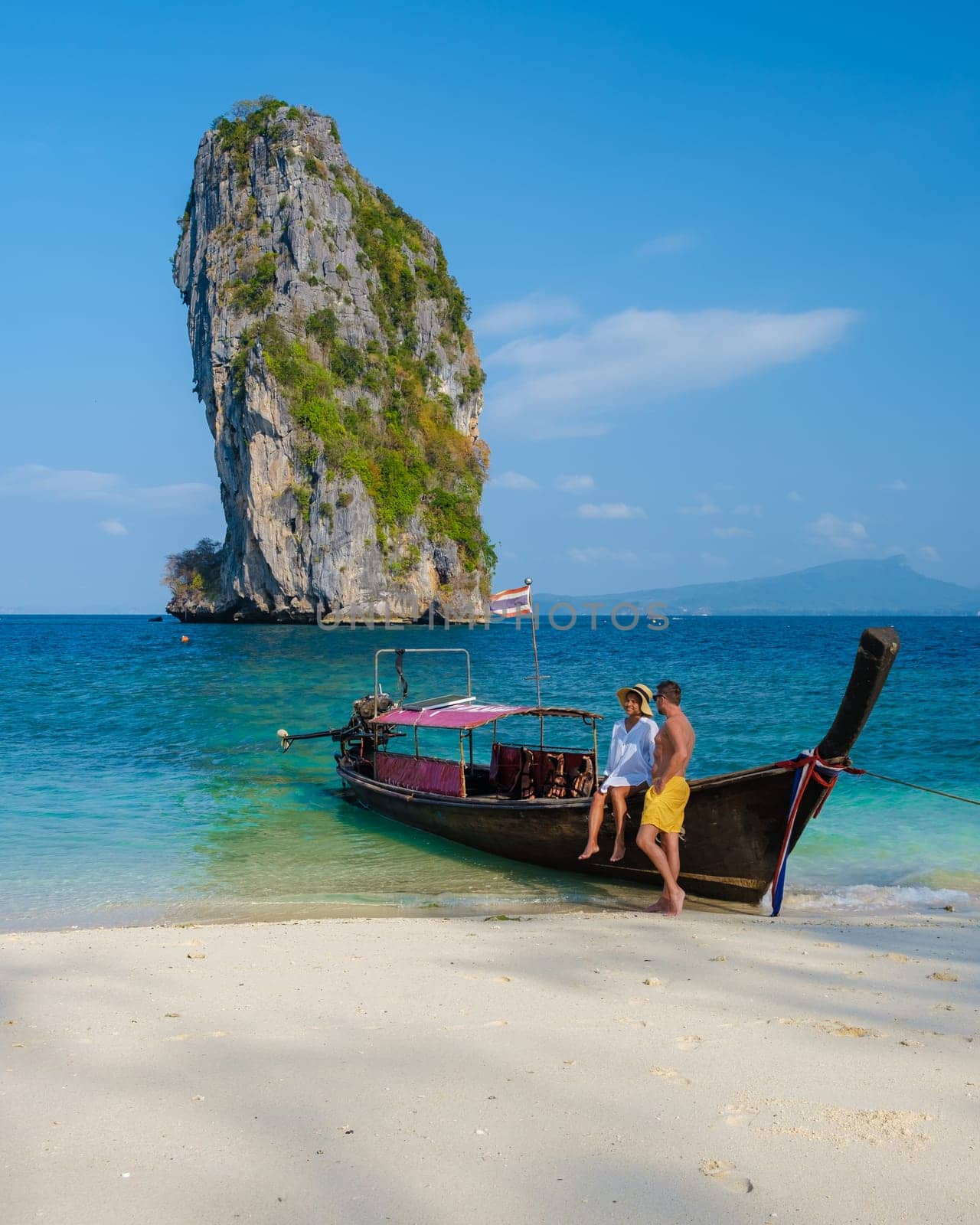 Railay Beach Krabi Thailand, a couple of men and woman on the beach in Thailand by fokkebok