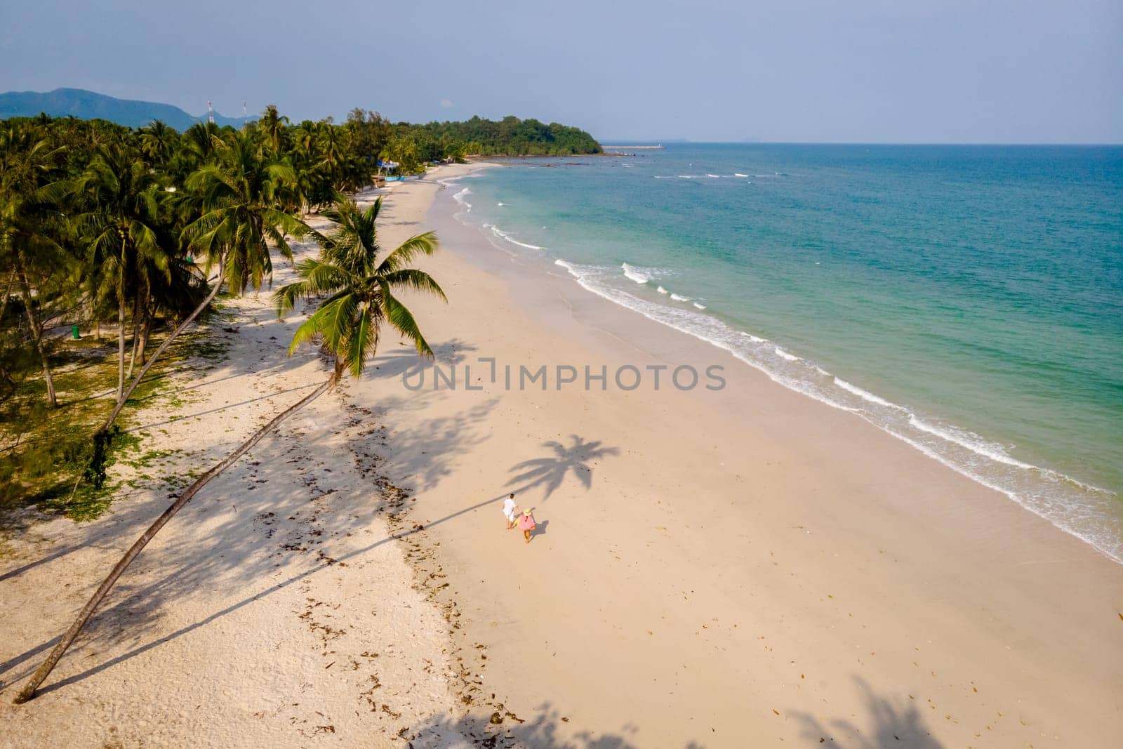 couple on vacation in Thailand, Chumpon province, white tropical beach with palm trees by fokkebok