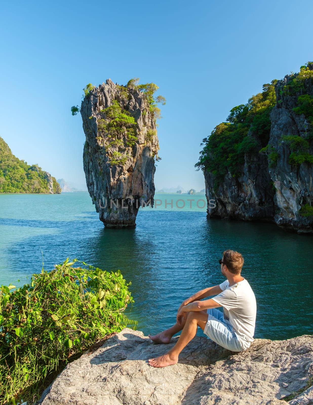 James Bond Island Phangnga Bay Thailand, young man visits the Island near Phuket Thailand, men on a boat trip at Phangnga Bay Thailand