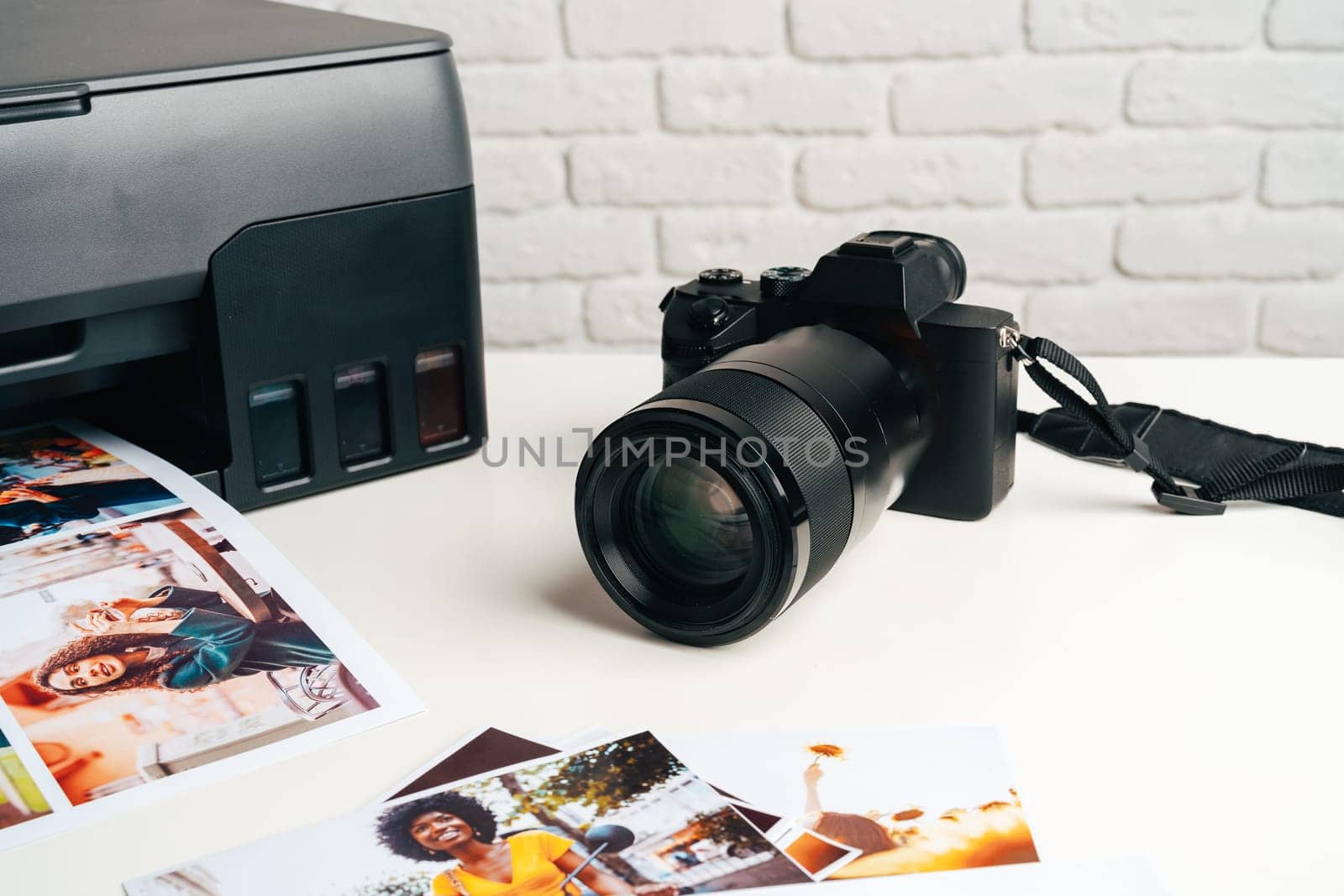 Printer and photo camera on table. Printing photos concept by Fabrikasimf