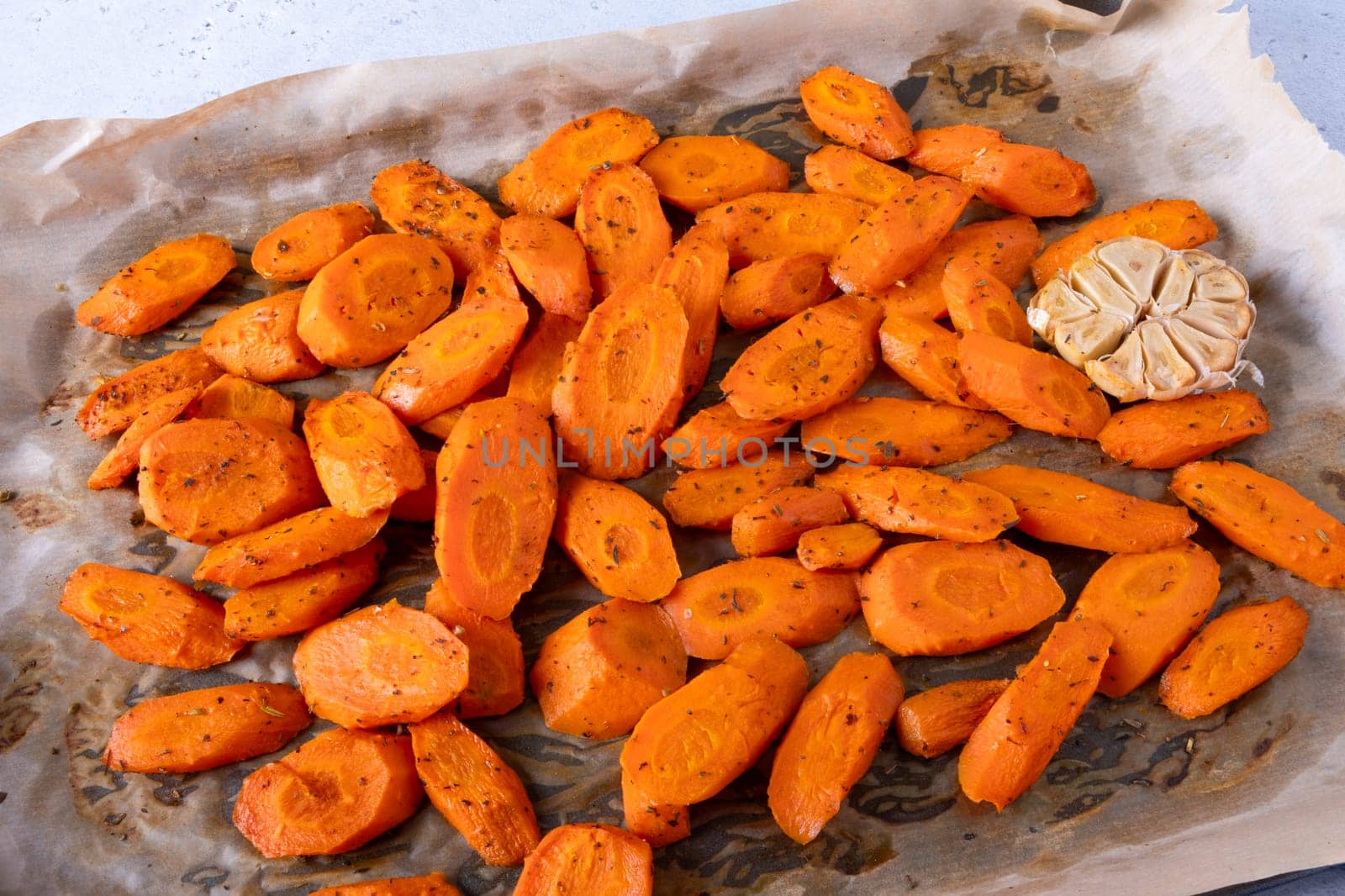 Baked carrots with spices on a baking tray. Selective focus by OlgaGubskaya