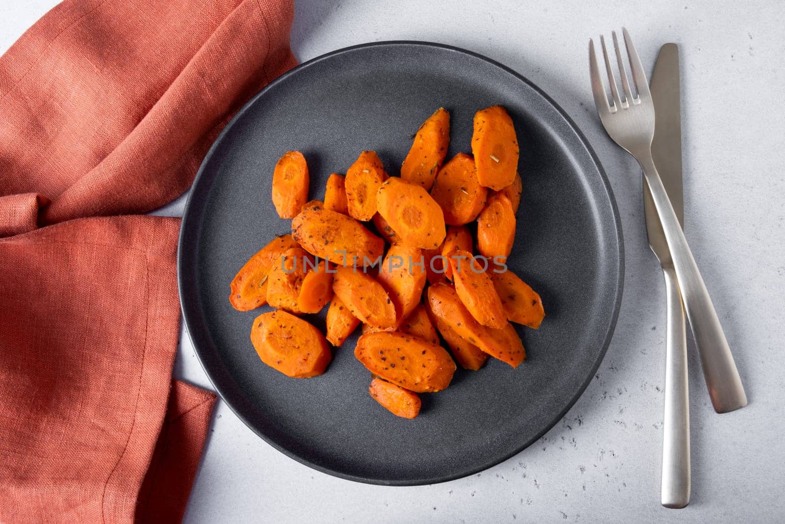 Baked carrots lie on a plate. Selective focus.