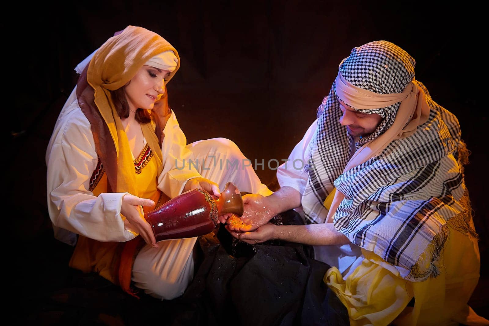 A couple in love or a married couple in stylized Eastern clothing from Israel, Palestine, Iran, Pakistan together. Tender photo session in the style of the Middle East and the Bible