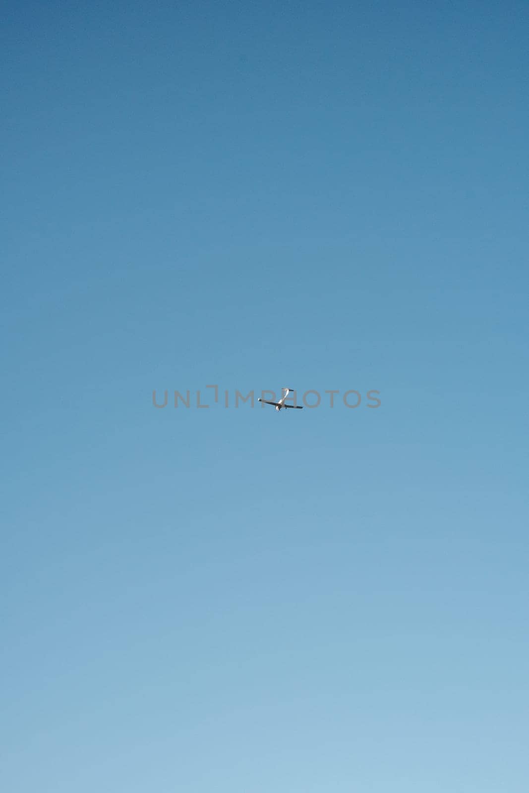 Jet Soaring Through Blue Sky