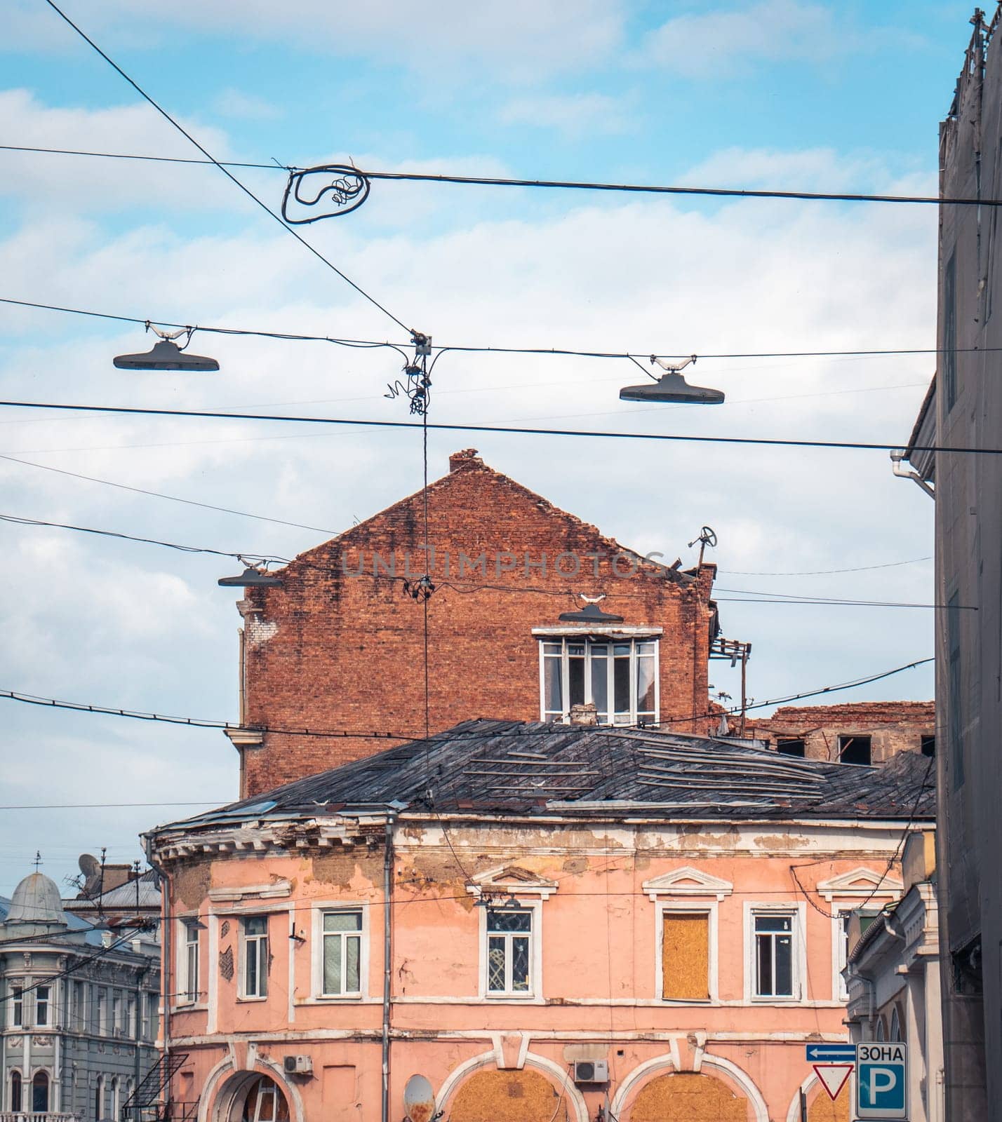 Old damaged architecture in Kharkiv in spring. Cityscape photo in Ukraine. Urban city life during the war. High quality picture for wallpaper, travel blog.