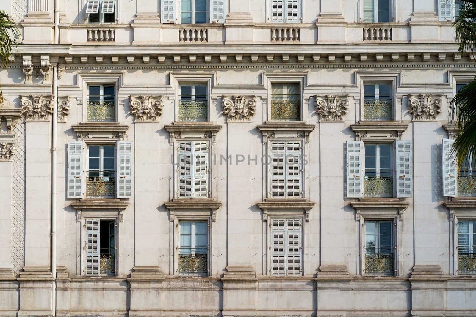 nice windows. beautiful windows with shutters. Beautiful wooden window shutter with windowsill, cement wall and sunny day