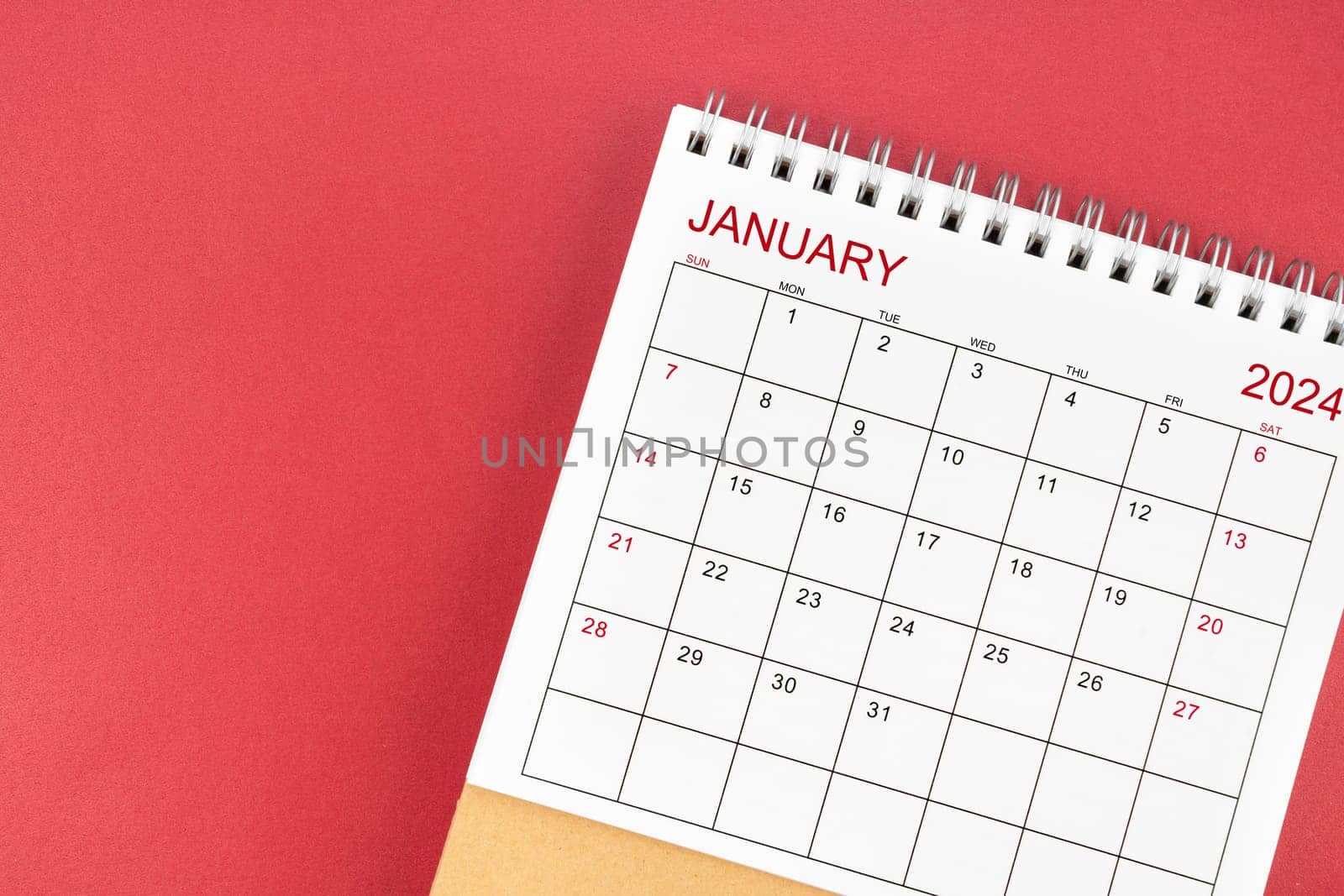 January 2024 desk calendar on red color background.